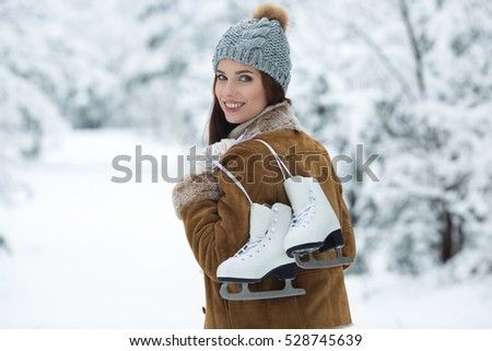 beautiful young woman with ice skates to go to the rink
