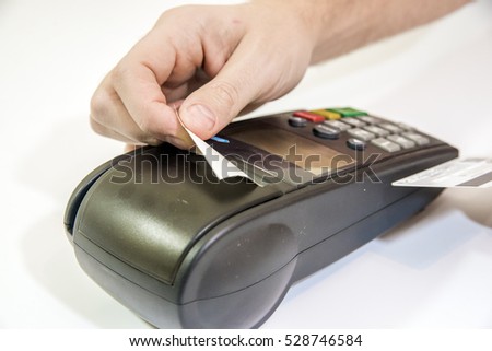 Payment with credit card - businessman holding pos terminal. hand pin code on pin pad of card machine or pos terminal 