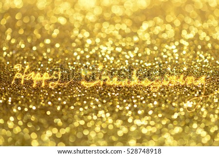 Happy thanksgiving written with sparkle firework on golden bokeh background, banner