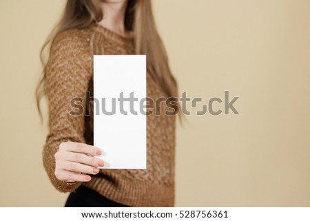 Girl showing blank white flyer brochure booklet. Leaflet presentation. Pamphlet hold hands. Woman show clear offset paper. Sheet template. Booklet design sheet display read first person.