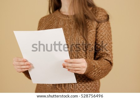 Girl reading blank white flyer brochure booklet. Leaflet presentation. Pamphlet hold hands. Woman show clear offset paper. Sheet template. Booklet design sheet display read first person.