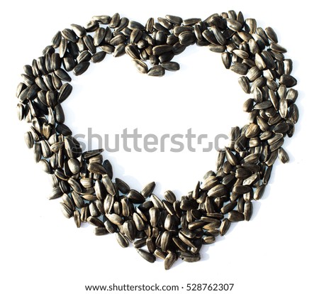 Heart the image from sunflower seeds on a white background isolated. Symbol of love and care heart.