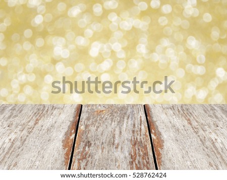 Wooden table on gold bokeh background