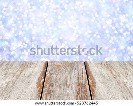 Wooden table on blue bokeh background