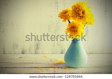 Home decor, yellow chrysanthemums in a blue vase, vintage photo