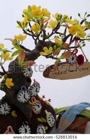 Amazing new year background from monkey to chicken year with yellow apricot blossom make from clay, knitted clock and animal from yarn, happy new year message for tet or lunar new year in Vietnam