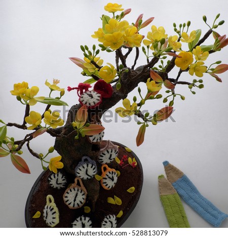 Amazing new year background from monkey to chicken year with yellow apricot blossom make from clay, knitted clock and animal from yarn, happy new year message for tet or lunar new year in Vietnam
