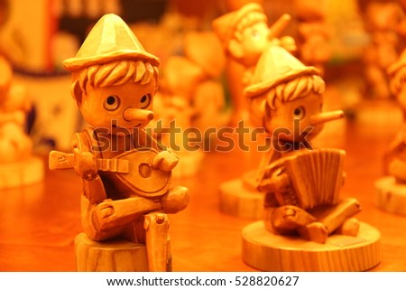 Wood pinocchios, in Italy Royalty-Free Stock Photo #528820627