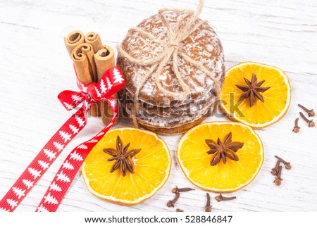 Christmas decoration with gingerbread cookies, cinnamon and orange slices .
