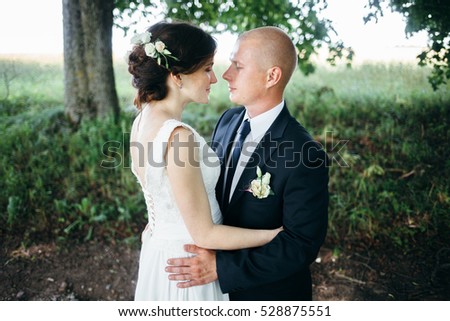 The bride and groom in the Park.A pair of newlyweds, the bride and groom at the wedding in the green forest nature kiss photo.Wedding Couple.Wedding walk 