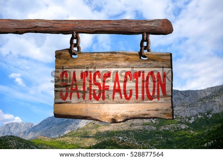 Satisfaction motivational phrase sign on old wood with blurred background