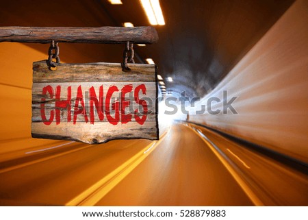Changes motivational phrase sign on old wood with blurred background