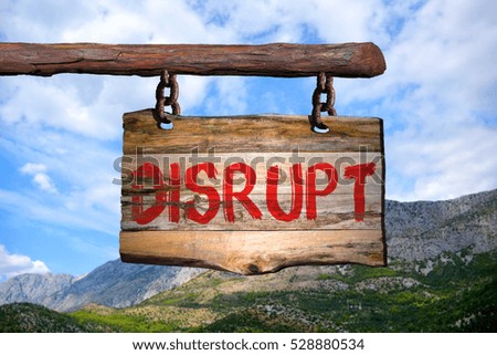 Disrupt motivational phrase sign on old wood with blurred background