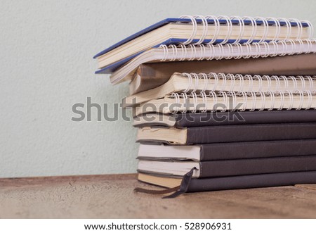 stack books on a wooden deck background