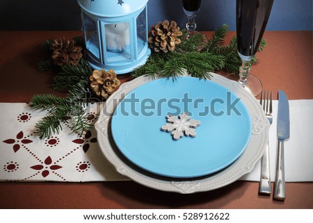 Christmas still life with plates and a candle