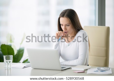 Young serious businesswoman working at the modern office desk with laptop, nervous breakdown, waiting for interview, exam, medical test result, financial issues anxiety, single woman depression Royalty-Free Stock Photo #528930568