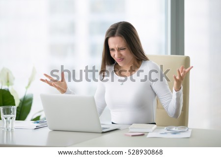 Young businesswoman at modern home office desk with laptop impressed by the bill to pay, revealed online affair, e-mail about broken romantic relationship, photo partner being unfaithful, system error Royalty-Free Stock Photo #528930868