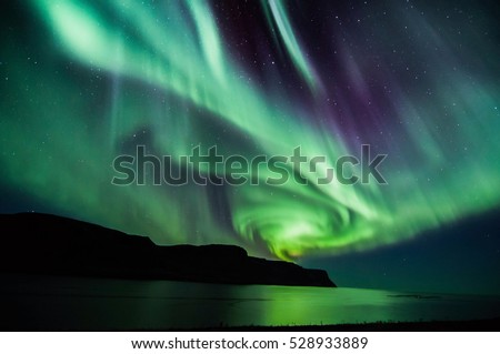 Icelandic spiral northern lights in autumn time Royalty-Free Stock Photo #528933889