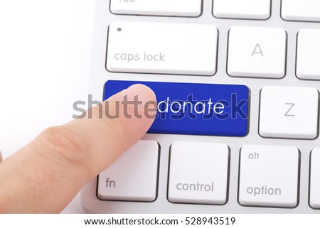 Donate word written on computer keyboard.