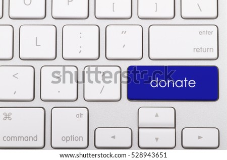 Donate word written on computer keyboard.