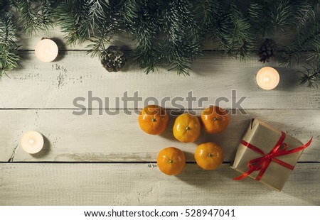 Christmas New year composition with tangerines on the old wooden background.Top view