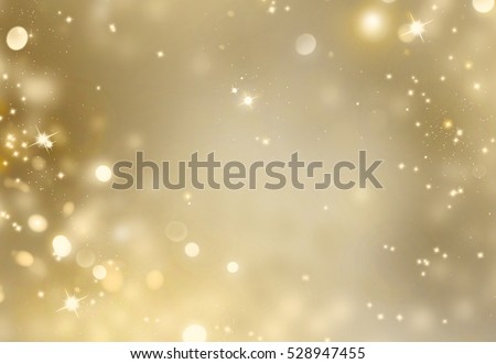 Christmas glowing Golden Background. Christmas lights. Gold Holiday New year Abstract Glitter Defocused Background With Blinking Stars and sparks. Blurred Bokeh. Royalty-Free Stock Photo #528947455