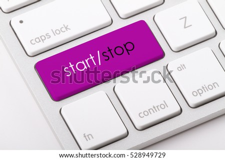 Start and Stop word written on computer keyboard.