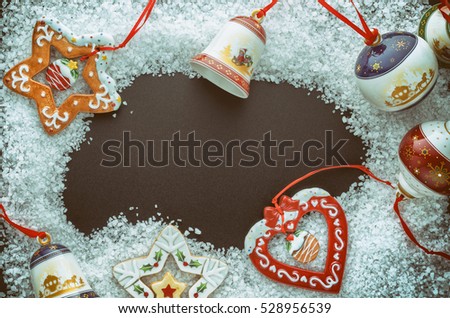 Christmas Tree Decorations (Balls, Bells, Heart, Star, Gingerbread Men) In The Snow (Large Sea Salt) On A Black Background. Close-Up. Free Space For Text. Top View.