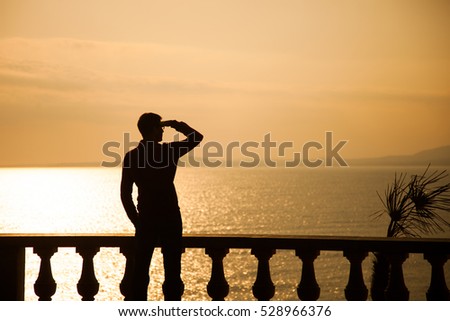 Silhouette in the Sea on Sunset Background
