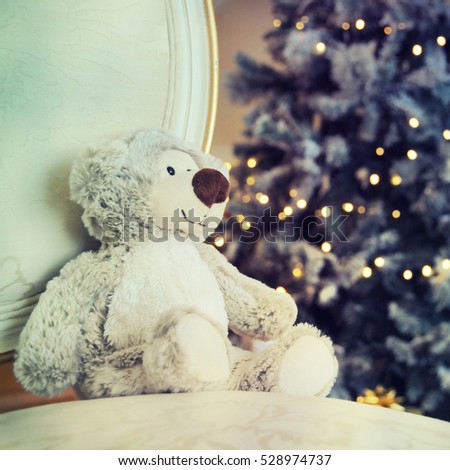 Toy bear against christmas tree background