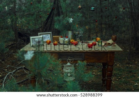 an old table stands in the woods around the Christmas tree decorated with toys on the table are various Christmas decor