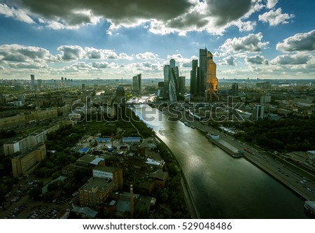 Moscow aerial view, Russia. Futuristic tall buildings of Moscow International Business Center (Moscow-City) in distance. Moscow skyline with Moskva River in twilight. Dark dramatic panorama background
