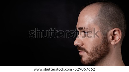 Handsome brutal close up side view portrait of fighter, worker, sportsman, strong person.