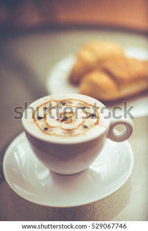 Cup of coffee with croissants on the table