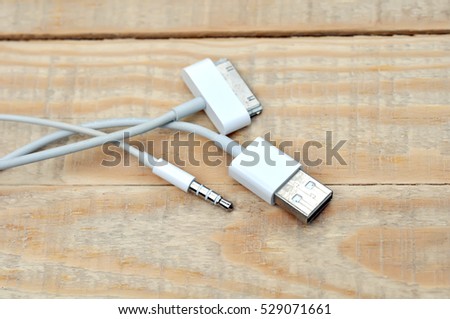 White usb mobile charging cable on wood table