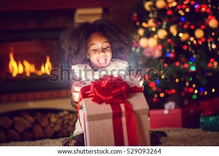 surprise girl opening Christmas magic presents
