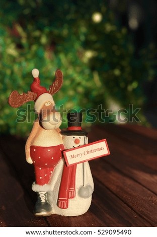 Vintage Christmas toys on the wooden background, elk and snowman
