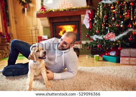 Man cuddling dog and enjoying for Christmas holiday 