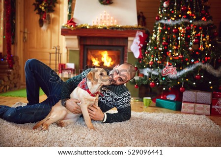 Man with nice dog having fun on Christmas holiday  