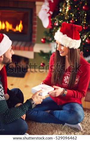 
Male and female giving gifts for Christmas