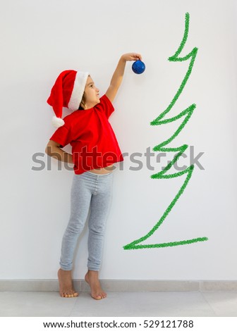Toddler boy decorating Christmas tree