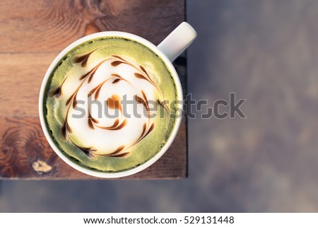 Green tea latte art on wooden table, Vintage tone