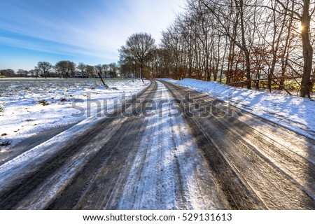 Glazed ice on a road in the Frisian countryside of the Netherlands