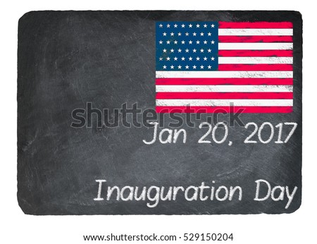 Inauguration Day written in chalk on a chalky natural slate blackboard isolated against white background with copy space