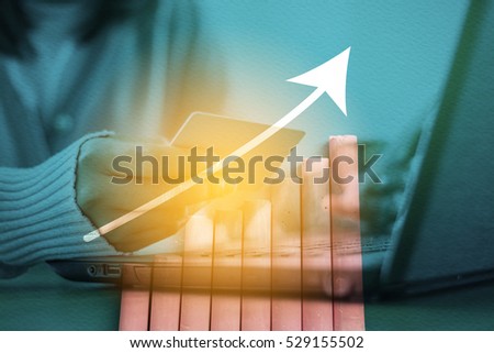 Double exposure of women use laptop and growing graph background