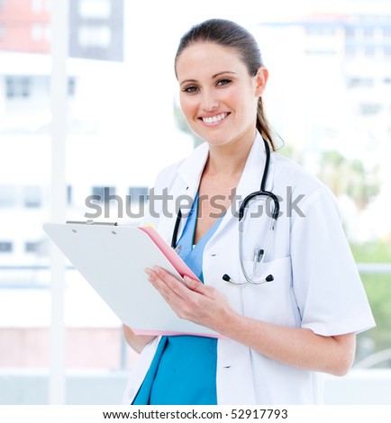 Nice female doctor writing her diagnosis in the hospital