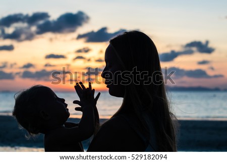 Young woman with child in the sea, holiday concept