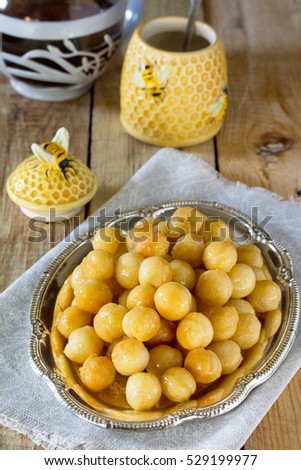 Loukoumades donuts with honey and cinnamon. The concept of celebrating Chanukah, traditional Jewish sweet table.