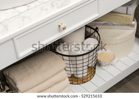 folded cotton towel under white marble bathroom marble counter