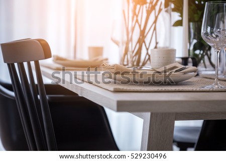 closed up nice dining chair with wooden table and dish sets interior design color tone with light flare effect